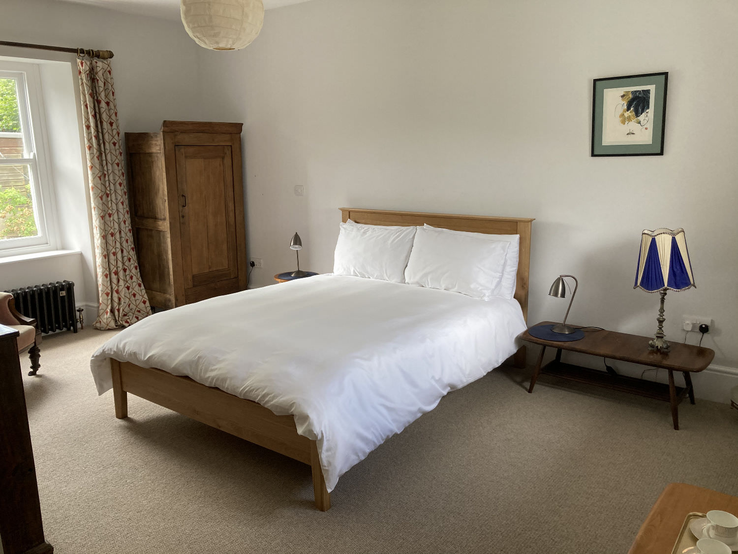 Image showing large double bedroom, white bed covers and other furniture.
